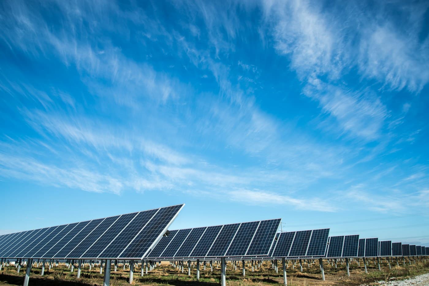 Real photovoltaic solar panel array under a blue sky